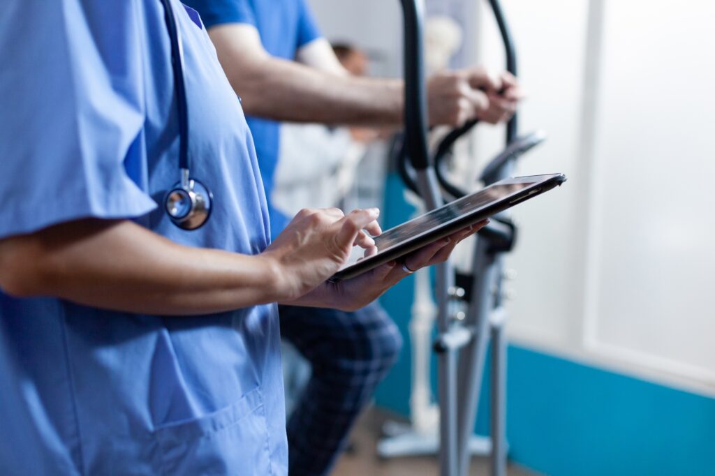 Close up of woman using digital tablet at recovery facility